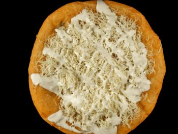 Hungarian Lángos - a Fried Bread with Cheese Topping